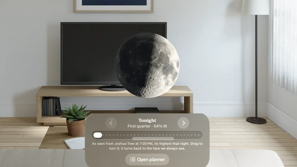 The first-quarter Moon, 54 percent lit, floating in a room on Apple Vision Pro above a control for the night, as seen from Joshua Tree at 7:05 PM.